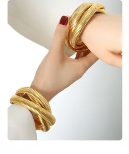 Close-up of gold-plated triple-layer snake coil bracelet with textured metallic finish