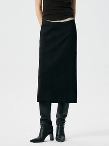 Minimalist black faux suede straight midi skirt with a side slit for elegant workwear look