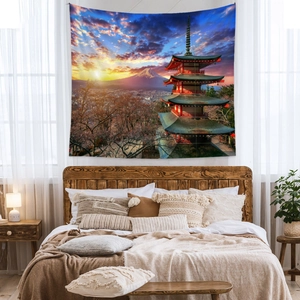 Mt Fuji sunset wall tapestry hanging above a bed with cozy boho style room decor