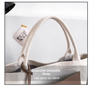 Detail of beige canvas tote bag showing thick handles and brown leather outer pocket