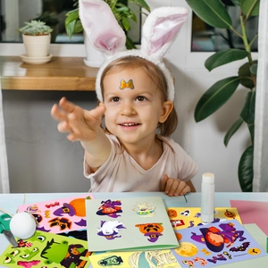 Girl crafting with Halloween ghost and pumpkin DIY stickers in a bright home setting