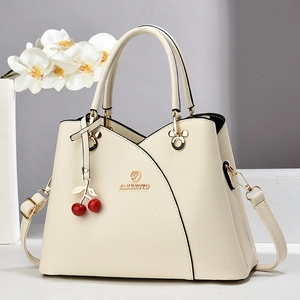 Elegant off-white PU leather handbag for women with V-stitch design and cherry pendant