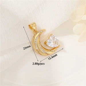 Macro view of 14K gold moon and heart zircon pendant measuring 23mm by 15.4mm