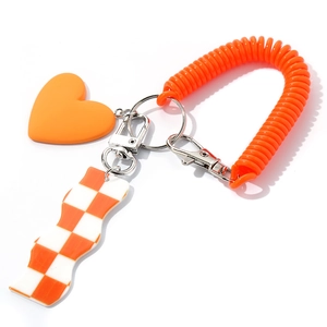 Orange heart keychain with checkerboard charm and spiral cord for bags or keys