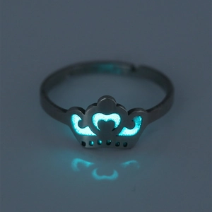 Detailed close-up of a crown-shaped stainless steel ring with blue luminous glow in the dark