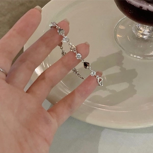 Detail of silver heart bracelet with sparkling zircon stones held in hand for close view
