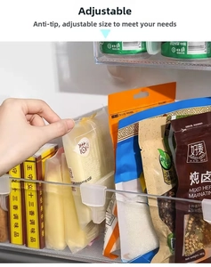 Close-up of adjustable clear plastic dividers for refrigerator side door storage organization