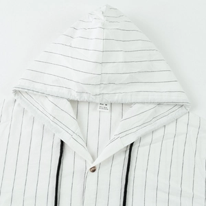 Detail of hood and neckline on a white striped linen shirt with black drawstring