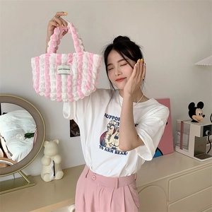 Detailed close-up of pink and white striped puffy tote bag with bubble texture fabric