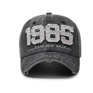 Vintage washed charcoal gray 1985 baseball cap with distressed brim for street style