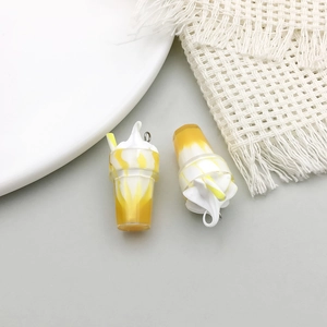 Detail of yellow and white resin ice cream sundae charms with metal rings for DIY jewelry