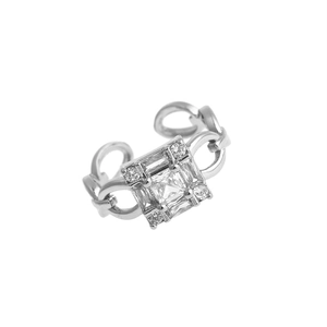 Macro shot of silver copper ring featuring square zircon stone and chain-link band detail