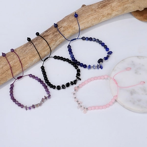 Macro detail of adjustable handmade braided bracelets with natural amethyst and quartz stones