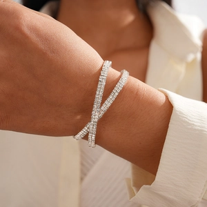 Close-up of sparkling silver multi-layer rhinestone criss-cross bracelet on wrist