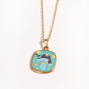 Detailed close-up of golden mushroom charm pendant with blue oil painting finish