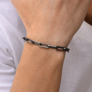 Macro shot of a men's matte gunmetal stainless steel paperclip chain bracelet on wrist