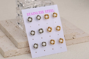 Macro shot of French vintage stainless steel rose flower earrings with pearls