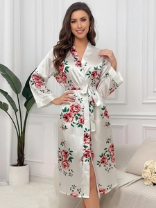 Detail of white floral satin robe showing silky fabric texture and red flower pattern