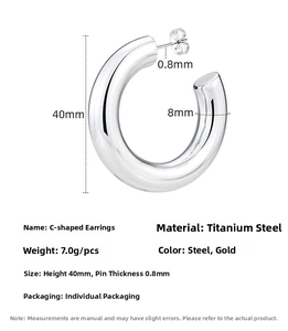 Detail of silver C-shaped titanium steel earrings with 40mm height and 8mm thickness