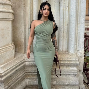 Detail of elegant sage green one-shoulder ruched maxi dress with high side slit