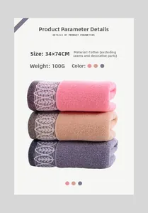Detailed view of 100% cotton towels showing leaf pattern jacquard and 34x74cm size specs
