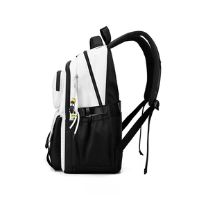 Side view detail of large black and white contrast backpack with neon green charm