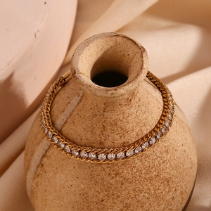 Detail of 18K gold plated triple-layer braided chain bracelet with zircon stone