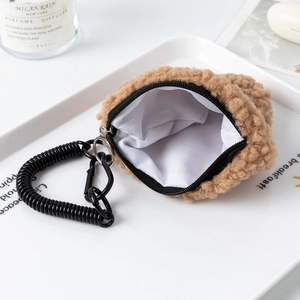 Detail of khaki plush coin purse with interior lining and sturdy metal carabiner clip