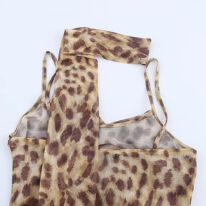 Detail of leopard print mesh bodysuit featuring sheer fabric and delicate halter neck straps