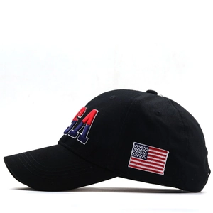 Close-up of USA embroidery and flag patch on black cotton baseball cap side view