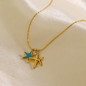 Minimalist gold starfish necklace with blue enamel charm and sparkling zircon accents