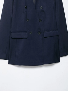 Detail of navy blue double-breasted blazer with six black buttons and flap pockets