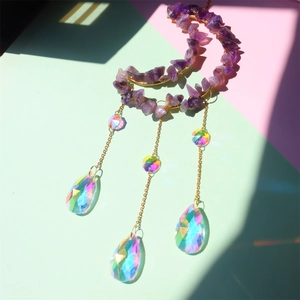 Detail of moon suncatcher with purple amethyst stones and rainbow crystal prisms