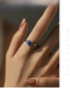 Macro shot of S925 sterling silver heart ring with blue opal and white zircon pave setting