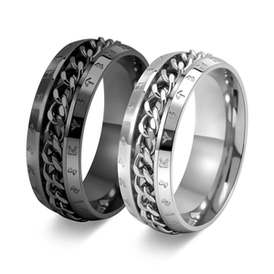 Macro shot of silver and black stainless steel rings with viking runes and chain inlay