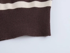 Close-up of ribbed knit hem on a striped sweater featuring brown and beige horizontal patterns