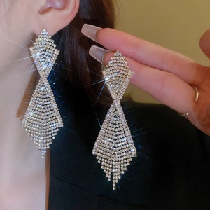 Detail shot of sparkling rhinestone fringe earrings with starburst light effect