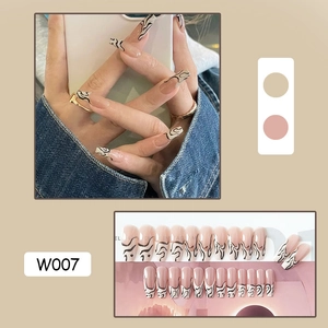 Detailed view of long square press-on nails with minimalist French nude and wave patterns