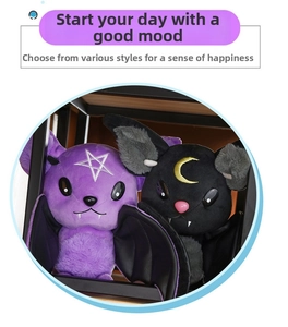 Detail of purple and black plush bat dolls with embroidered star and crescent moon designs