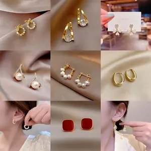 Collection of nine stylish gold earrings with pearls and crystals in a 9-grid display