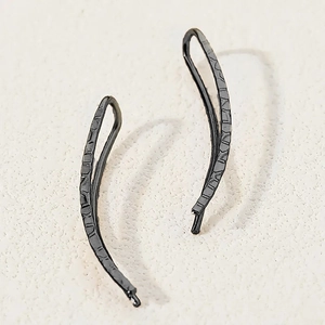 Minimalist black textured metal ear crawlers with stylish curved design for women