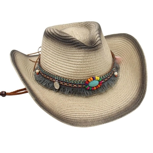 Detailed close-up of a bohemian straw cowboy hat with turquoise bead and tassel decor