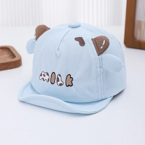 Detail of baby cow hat with 3D ears, waffle texture fabric, and MILK embroidery