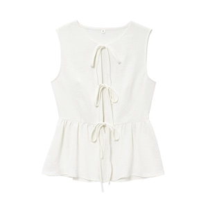 Detail of white sleeveless tie-front top with ruffled hem and drawstring closure