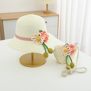 Straw sun hat and floral bag set for girls with pink ribbon and knit pom decorations