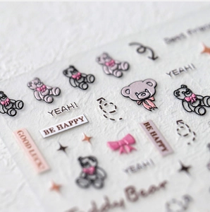 Close-up of 3D embossed nail stickers featuring cartoon bears and pink bows