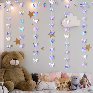 Holographic butterfly garlands hanging in a dreamy nursery with soft purple tones