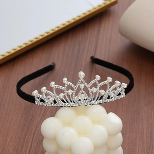 Detail of silver crown headband with sparkling rhinestones and elegant white pearls
