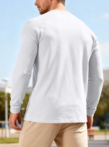 Outdoor back view of men's white waffle knit long sleeve henley shirt with textured fabric