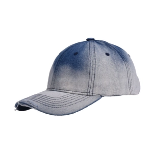 Detail of distressed tie-dye denim baseball cap featuring vintage frayed edge on the brim